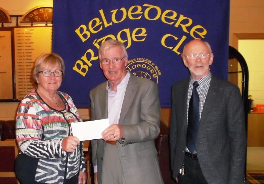 Deirdre from Midland Samaritans receives a cheque from Frank Maher, President Belvedere Bridge Clubith on Right Kieron, Midland Samaritans