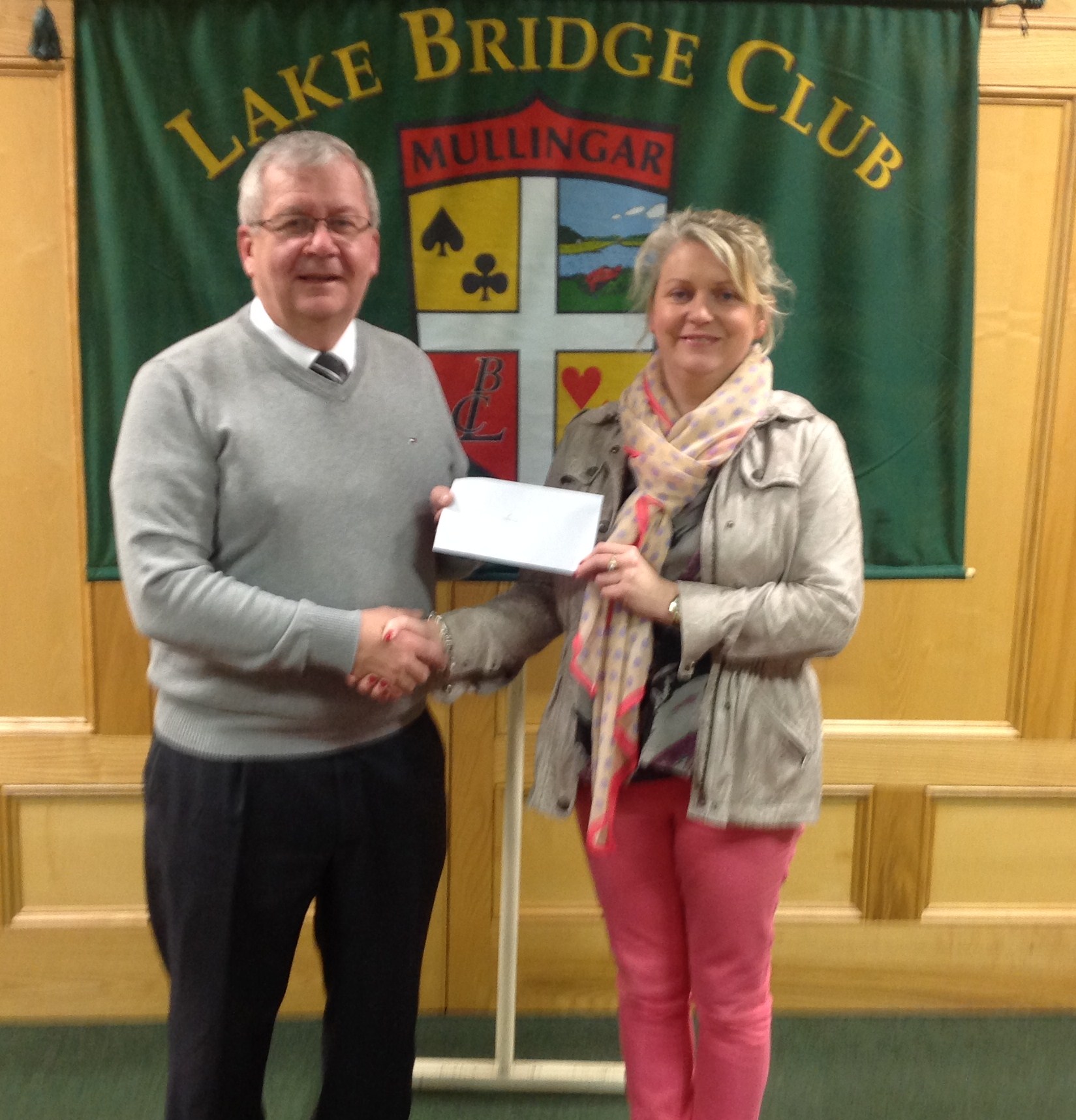 Lake Club President Gerry O'Gorman presenting a cheque to Bernie McHugh from LARCC.